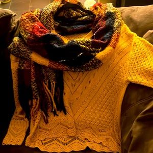 Maurice’s mustard sweater and scarf.